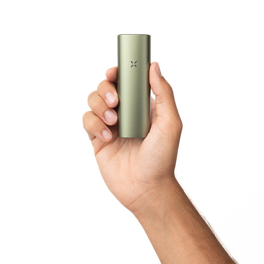 Hand holding the PAX 4 dry herb vaporizer in Greenstone finish.